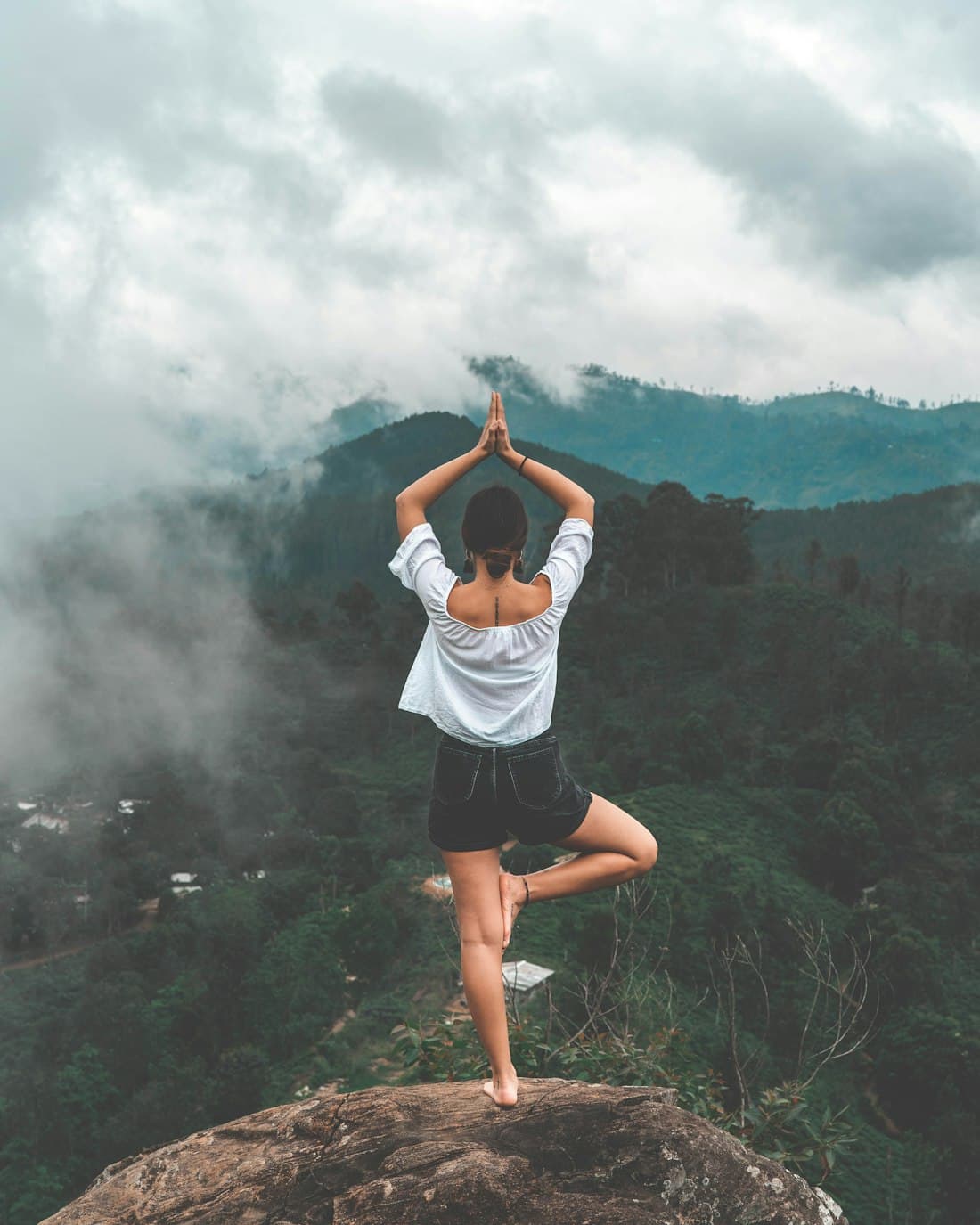 A person standing calmly on a misty hilltop