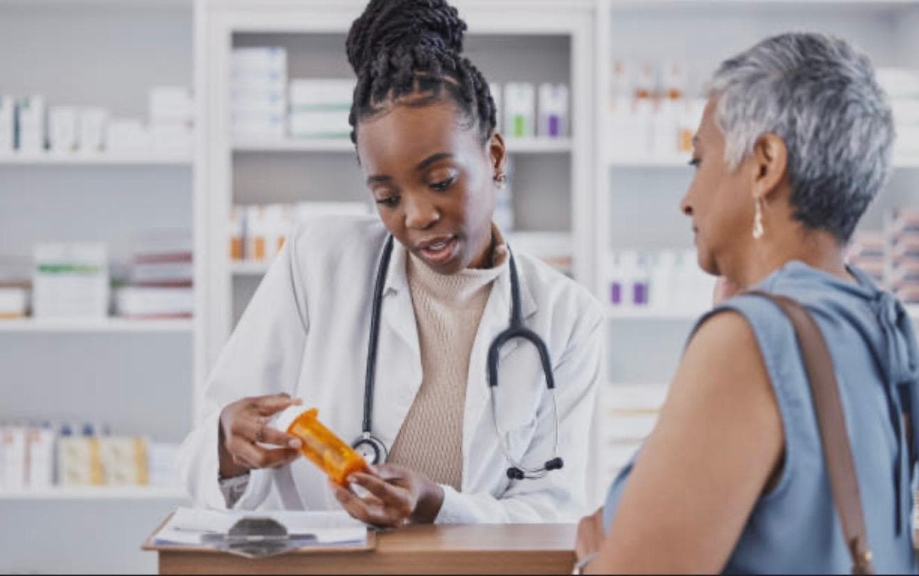 A provider reviewing and dispensing medication with a patient