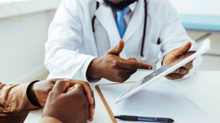 A provider explaining findings to a patient during an assessment