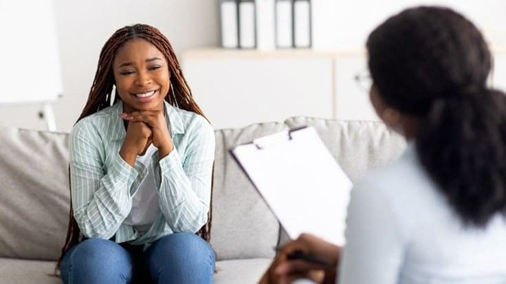 A provider and patient sharing a positive moment during a session