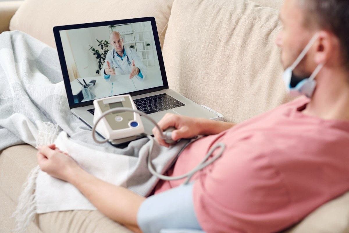 A patient at home during a live video visit with a clinician